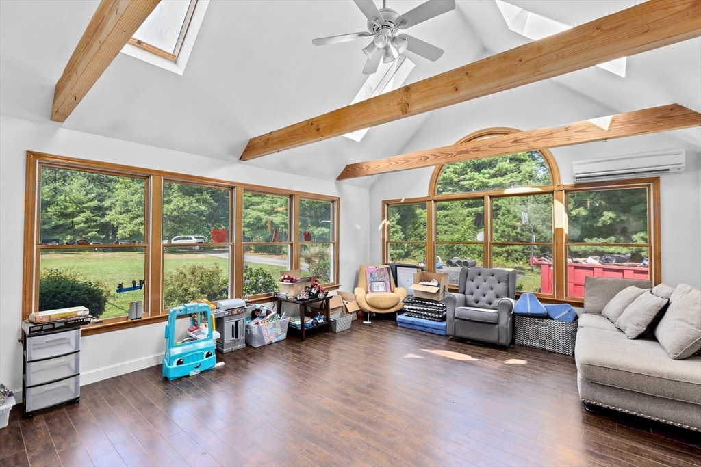 a living room with furniture and floor to ceiling windows