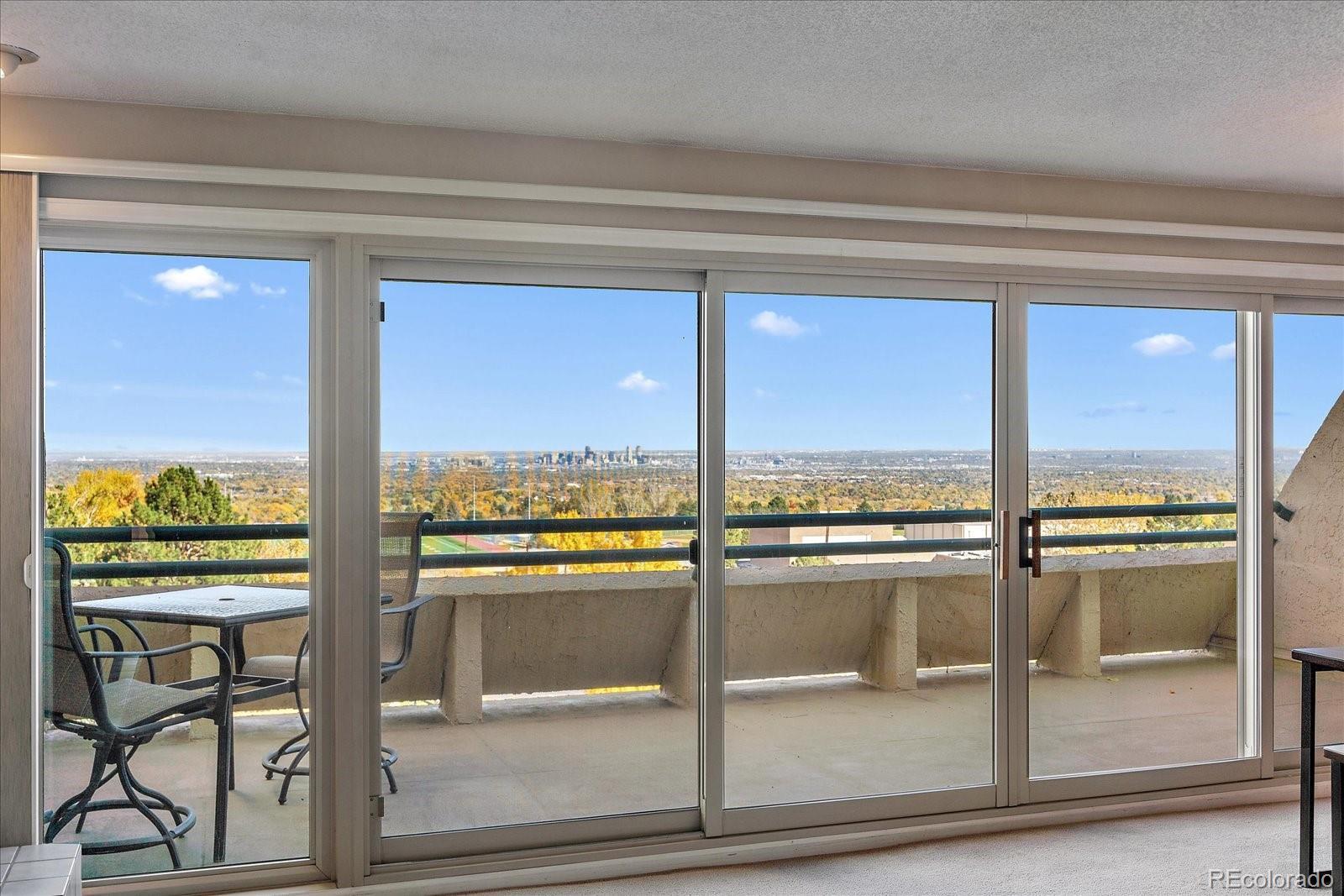 a view of a living room and floor to ceiling window with an outdoor view