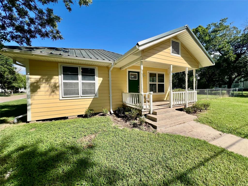 a view of a house with backyard porch and sitting area