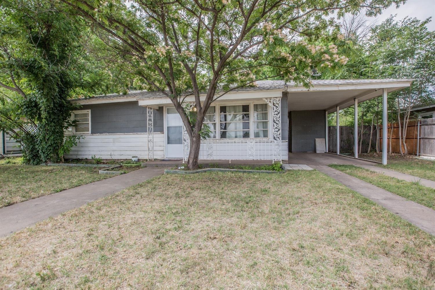 front view of a house with a trees