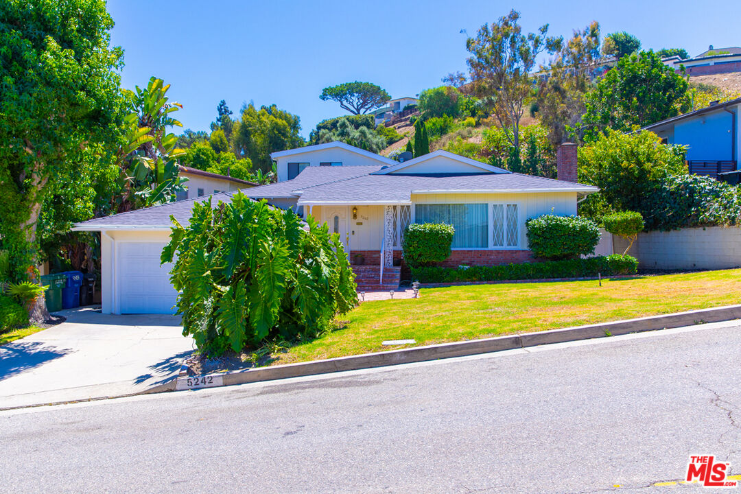 a front view of house with yard and outdoor seating