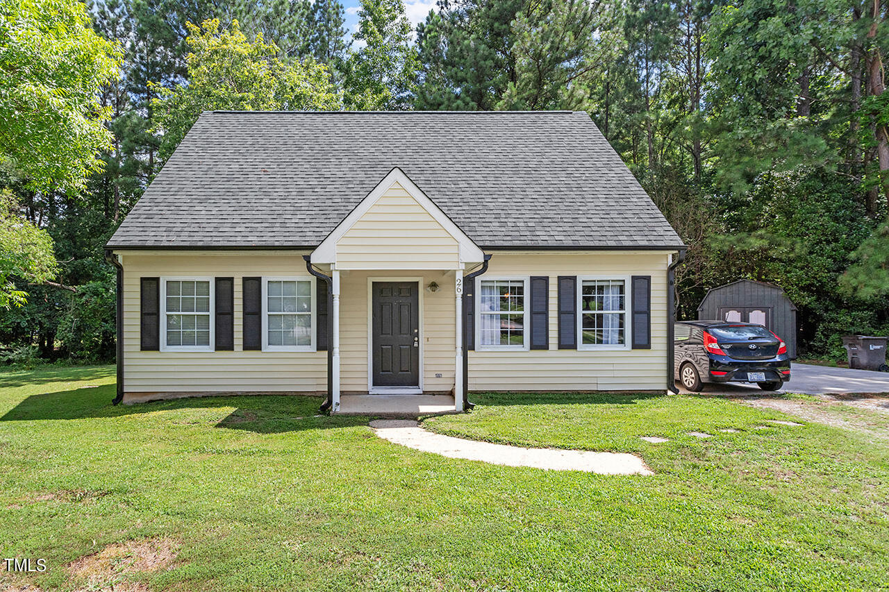 a front view of house with yard and green space