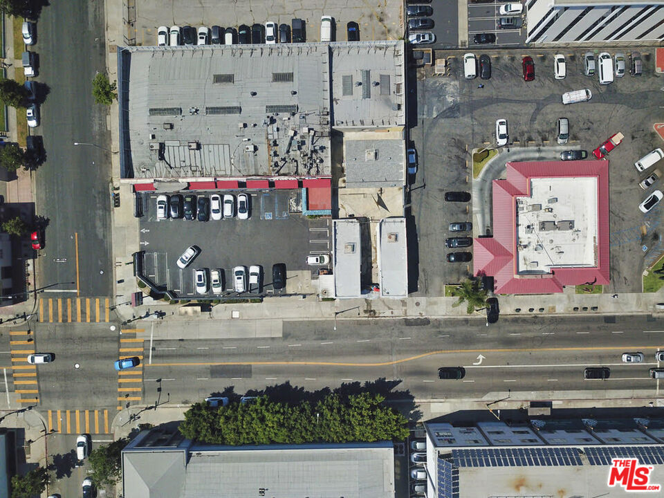 an aerial view of multi story residential apartment building with yard