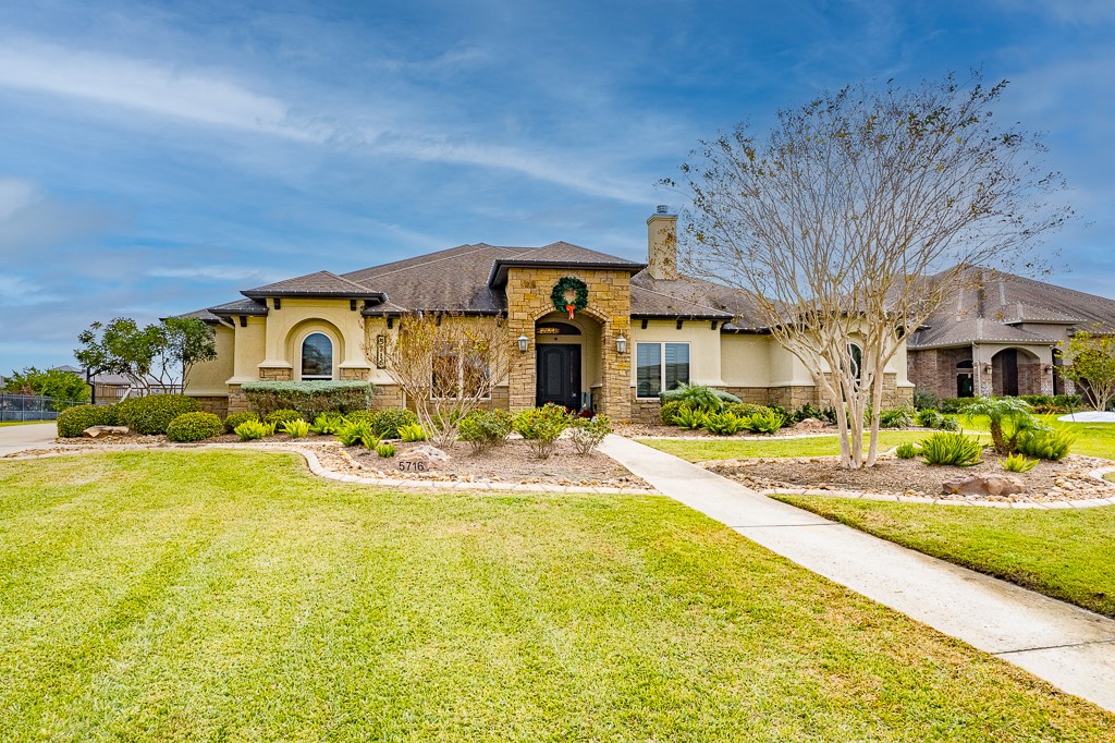 a front view of house with outdoor space and swimming pool