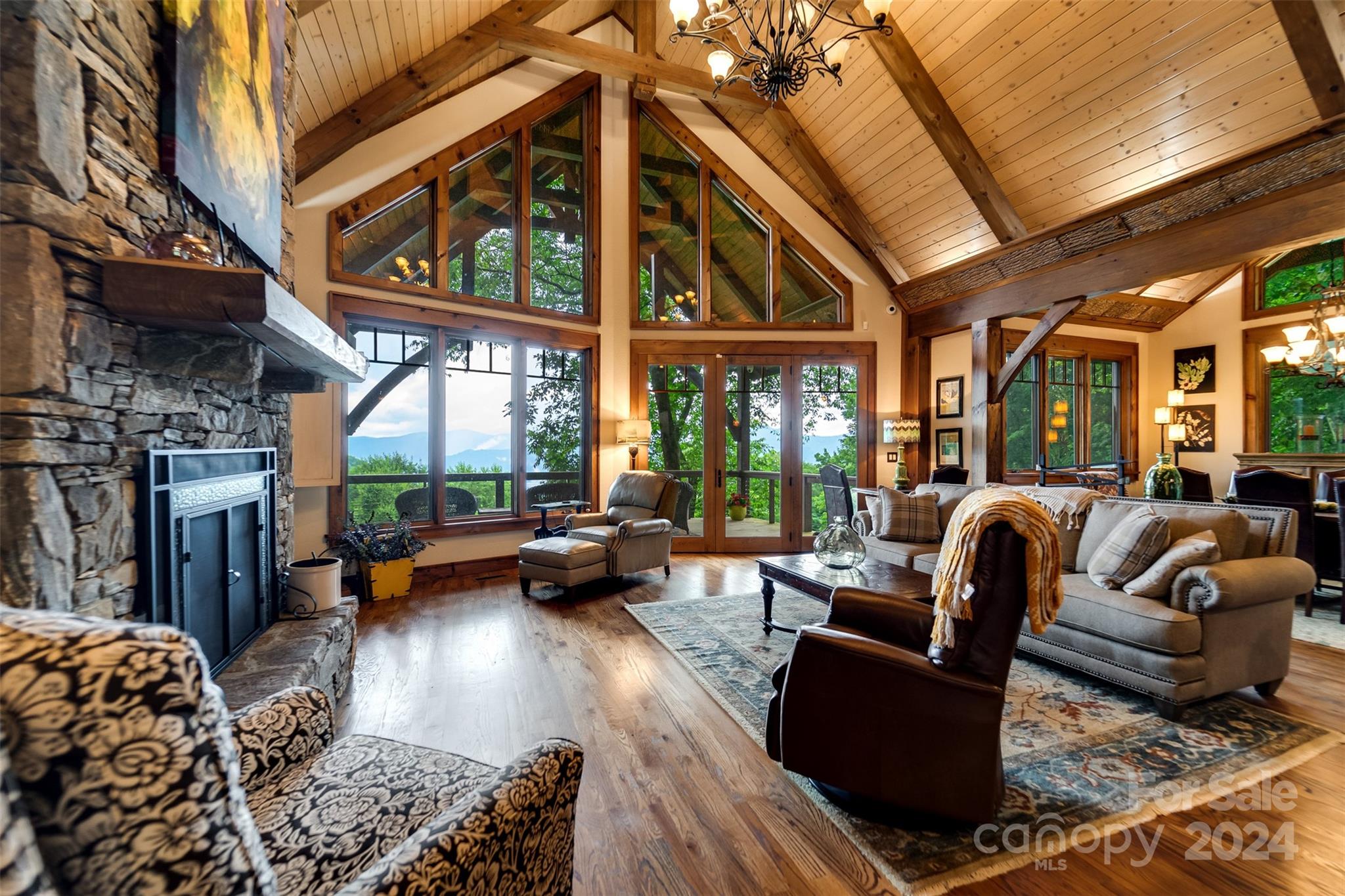 a living room with fireplace furniture and a large window