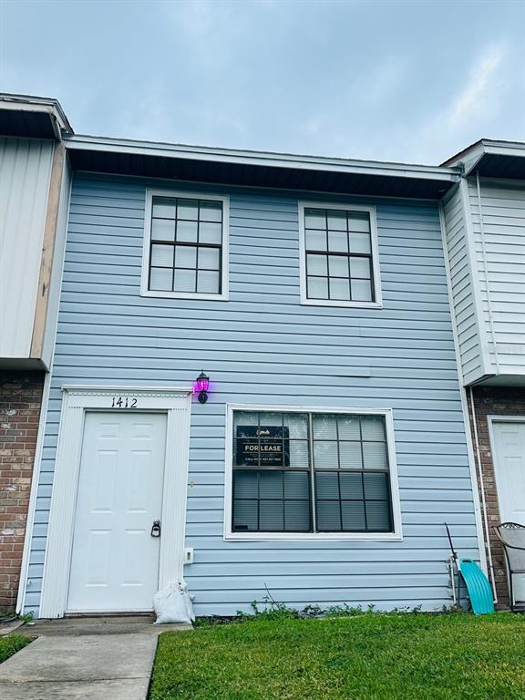 a view of a house with more windows and a yard