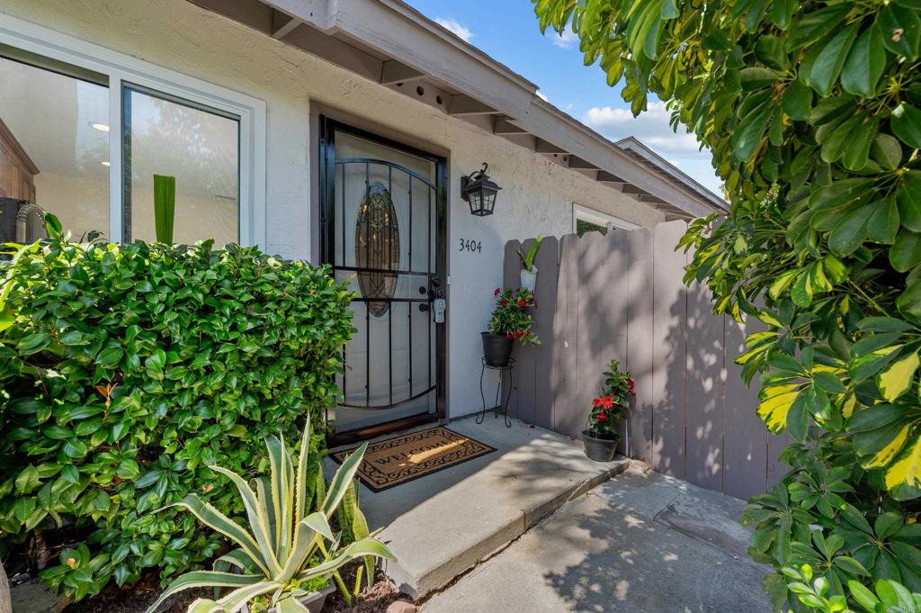 front view of a house with potted plants