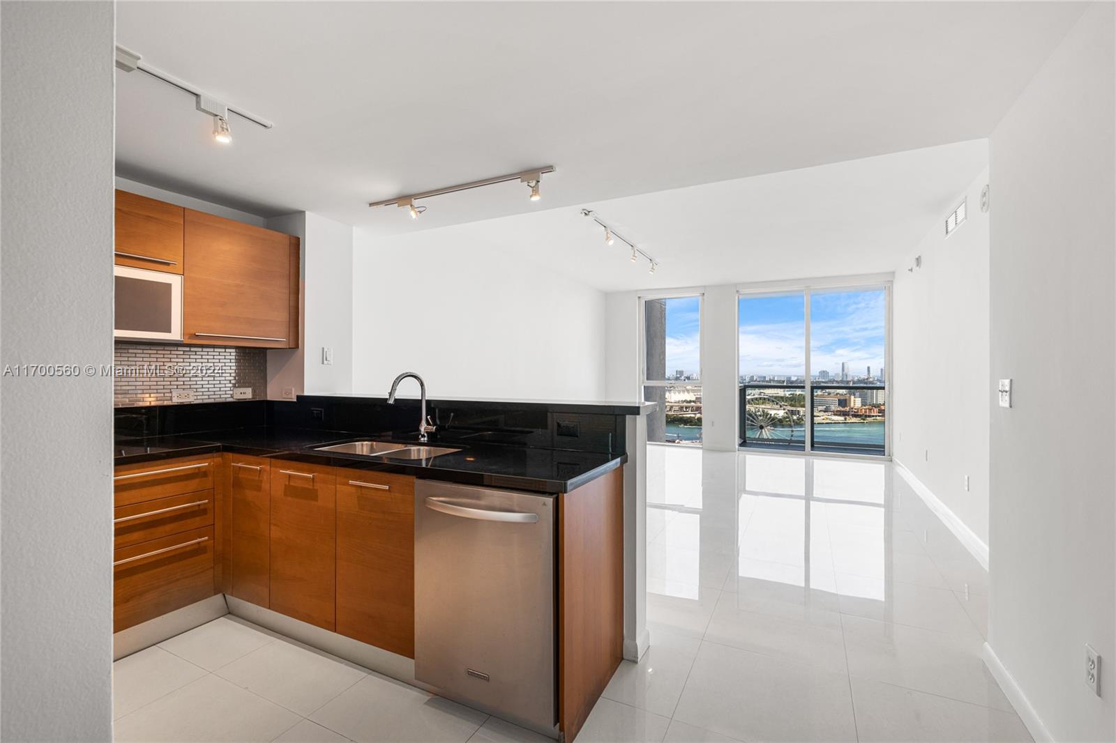 a kitchen with stainless steel appliances granite countertop a sink and a stove