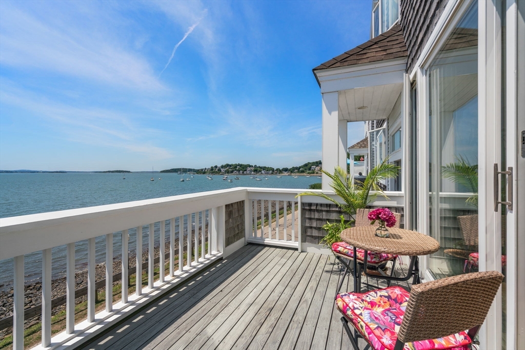 a view of balcony with wooden floor and outdoor seating