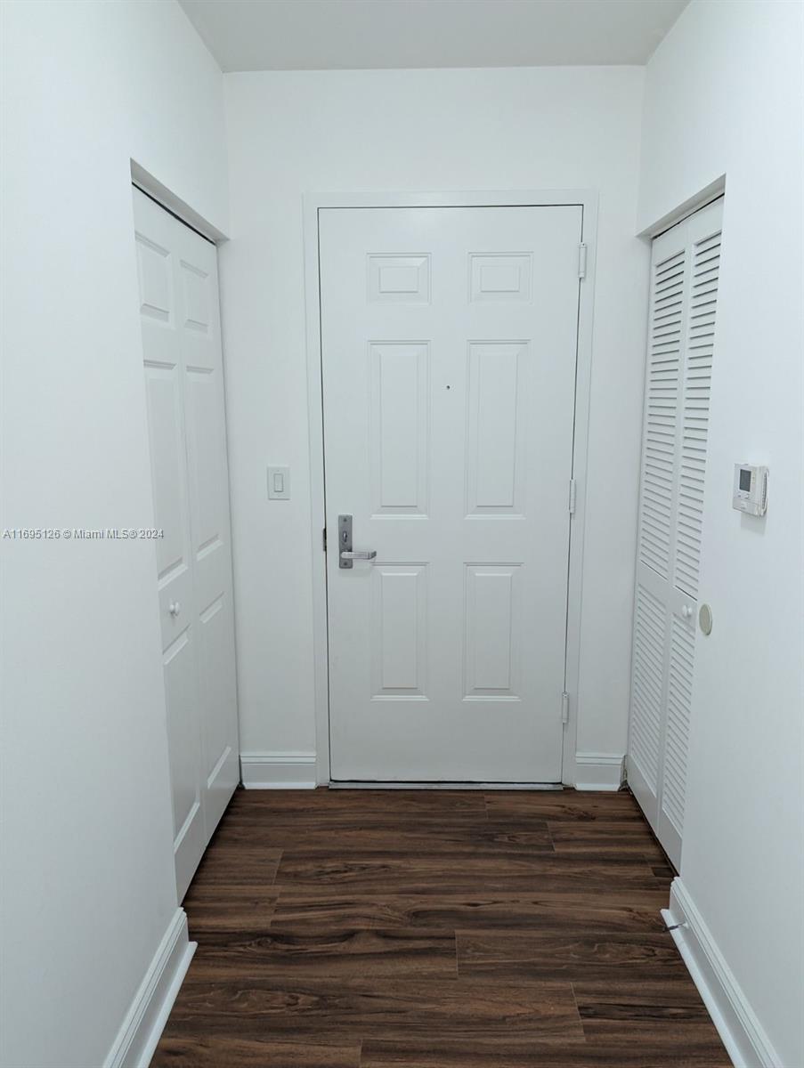 a view of a room with wooden floor