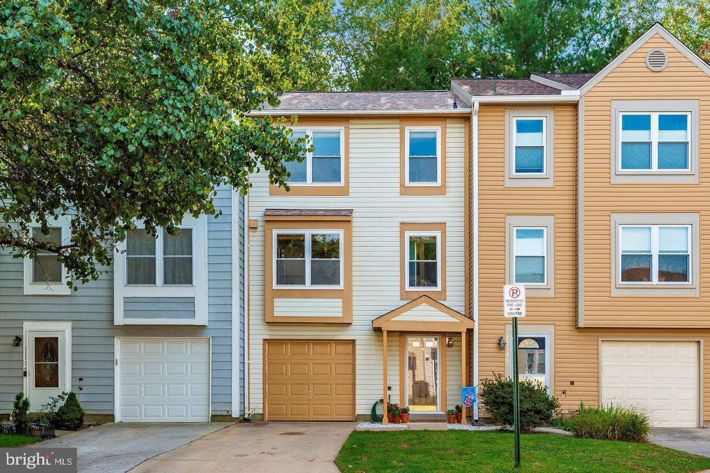 a front view of a residential apartment building with a yard