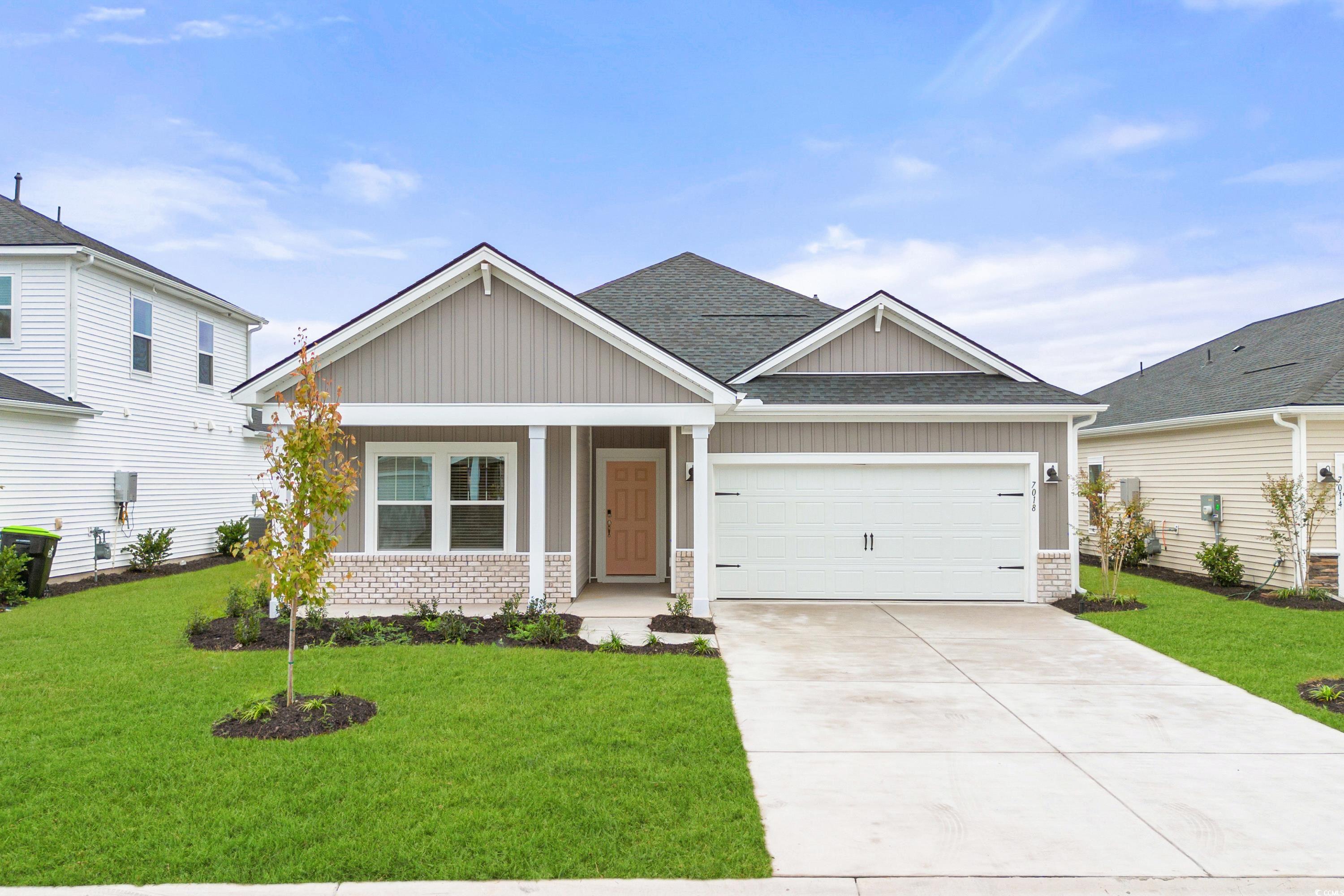 Craftsman inspired home featuring a garage and a f