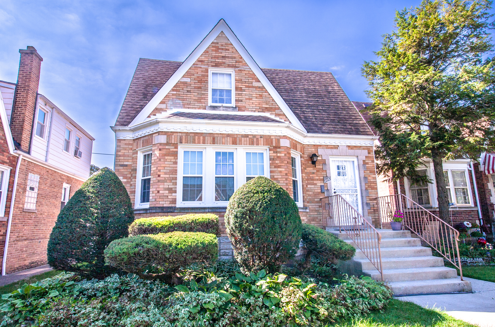 a view of a brick house with a yard