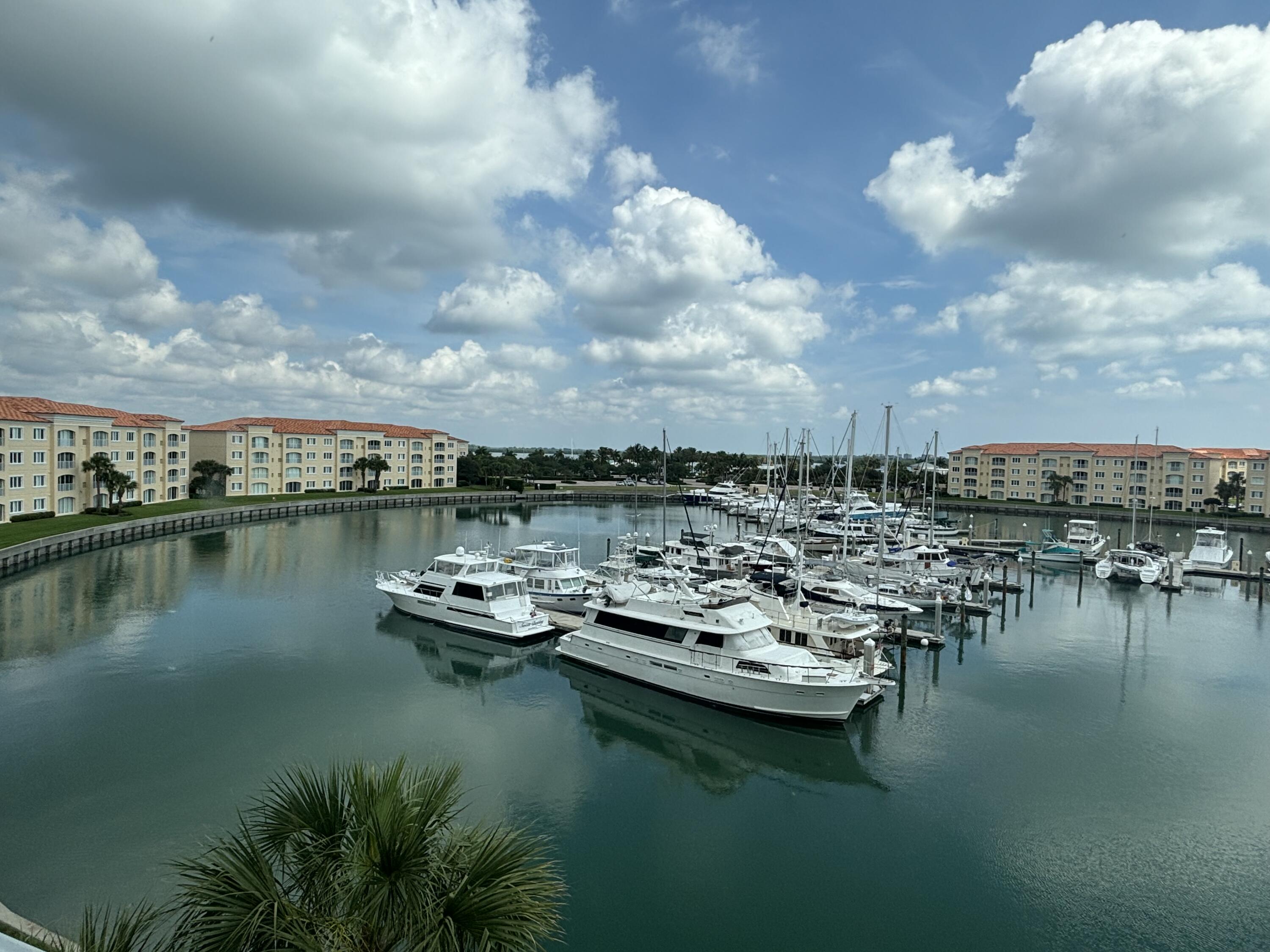 a view of a water with boats and trees in the background