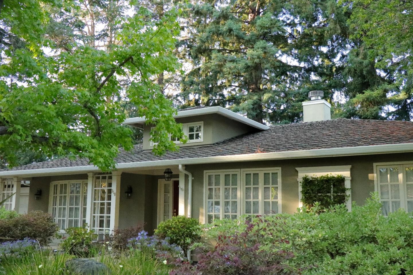 a front view of a house with a garden