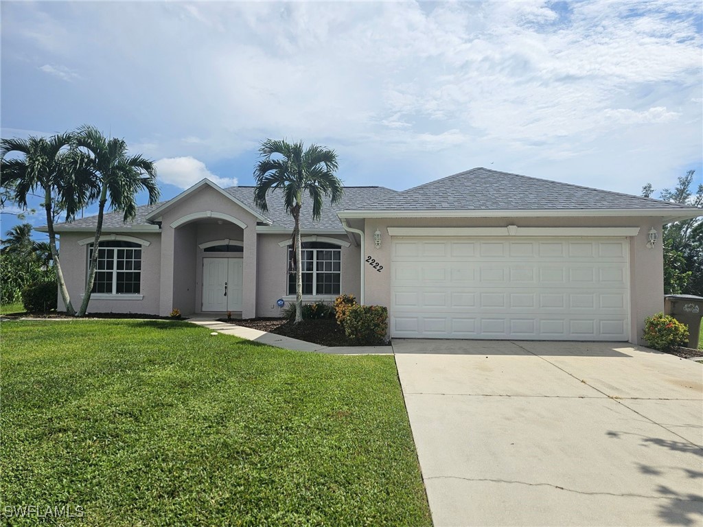 a front view of a house with a yard and garage