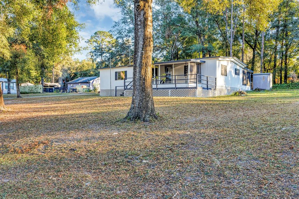 a front view of a house with a yard and trees