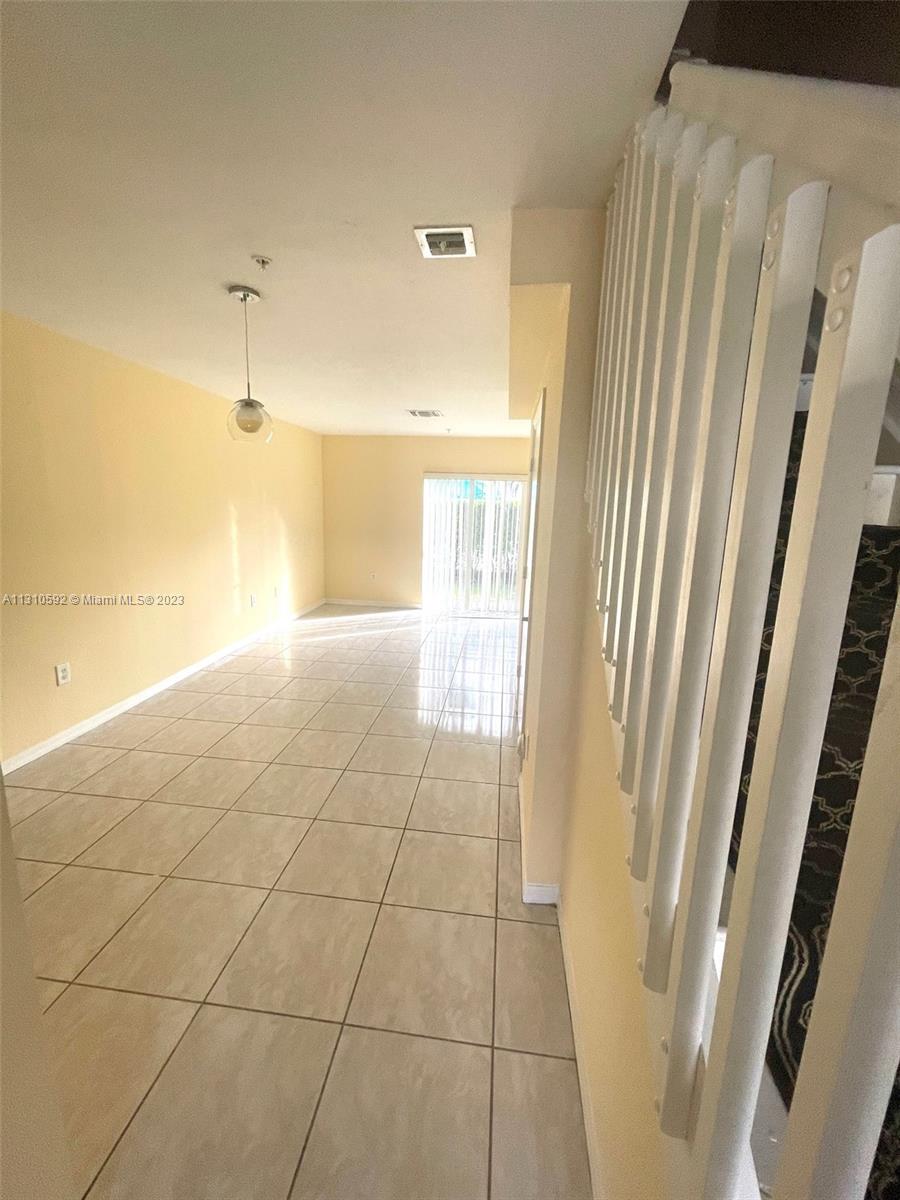 a view of a livingroom with an empty space and a window