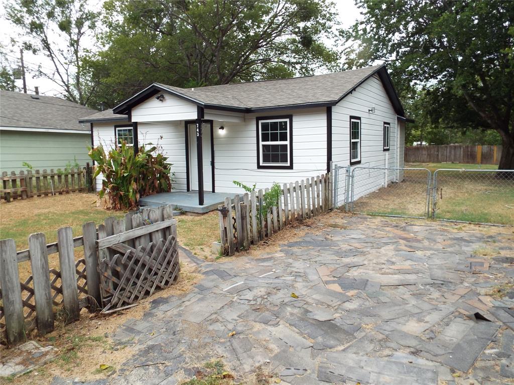 a view of a house with wooden fence