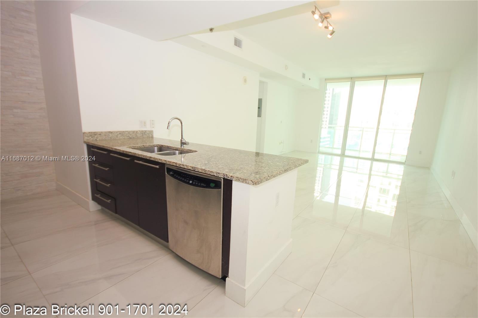 a kitchen with stainless steel appliances granite countertop a sink and a granite counter tops