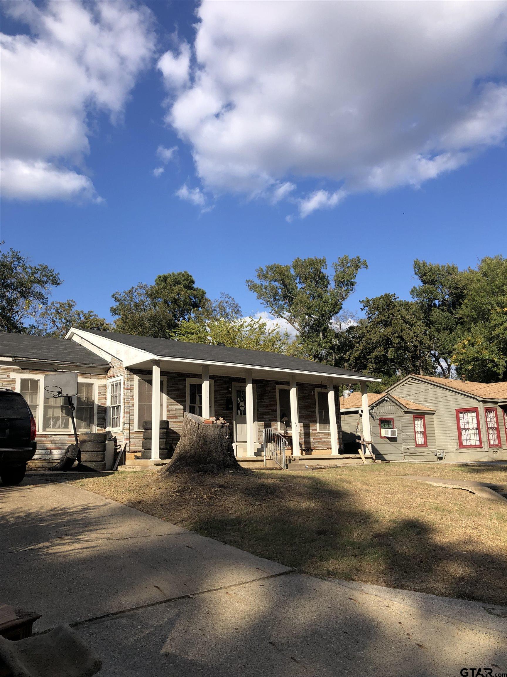 a front view of a house with a yard and balcony