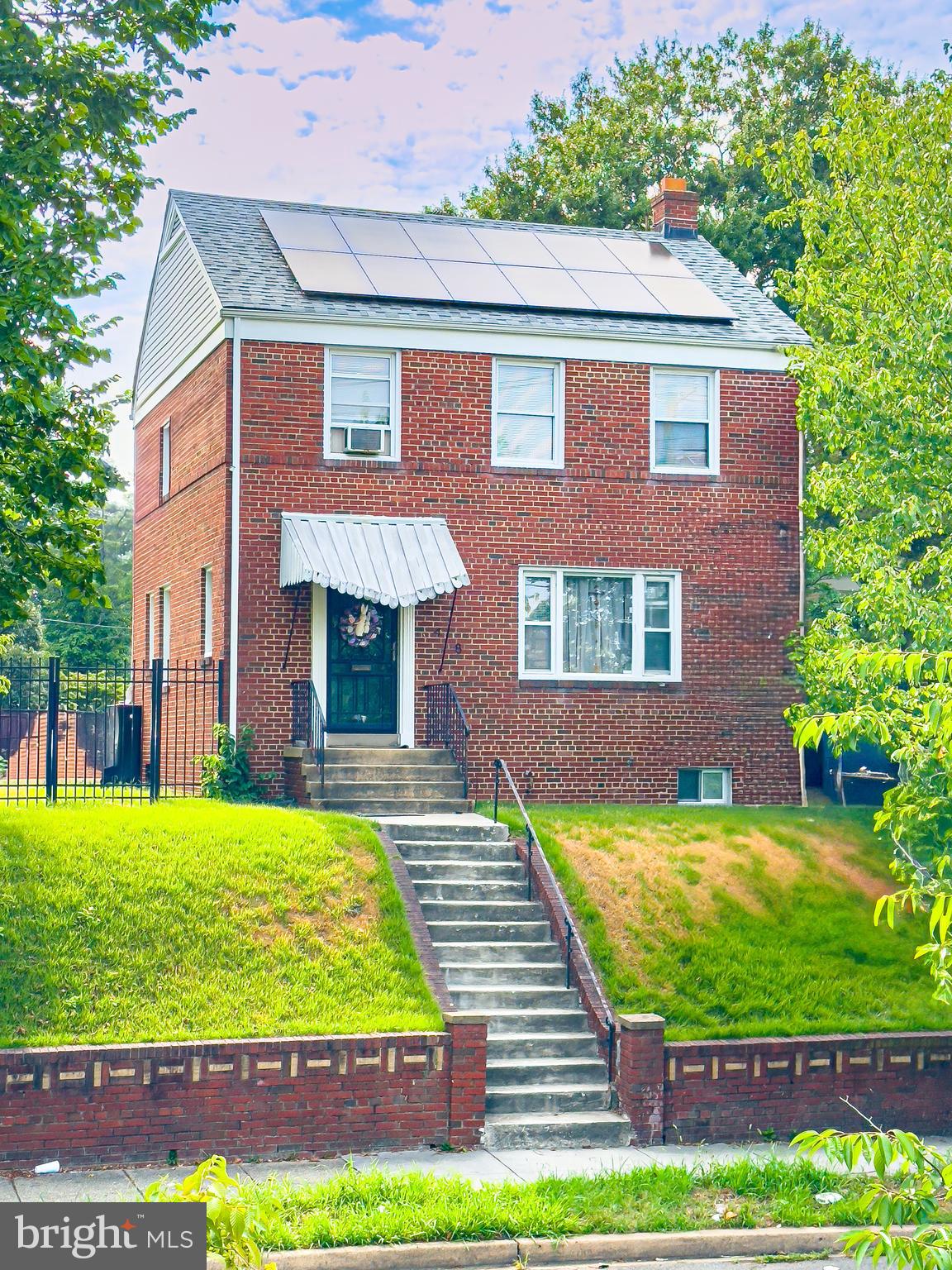 a view of a house with a yard and plants