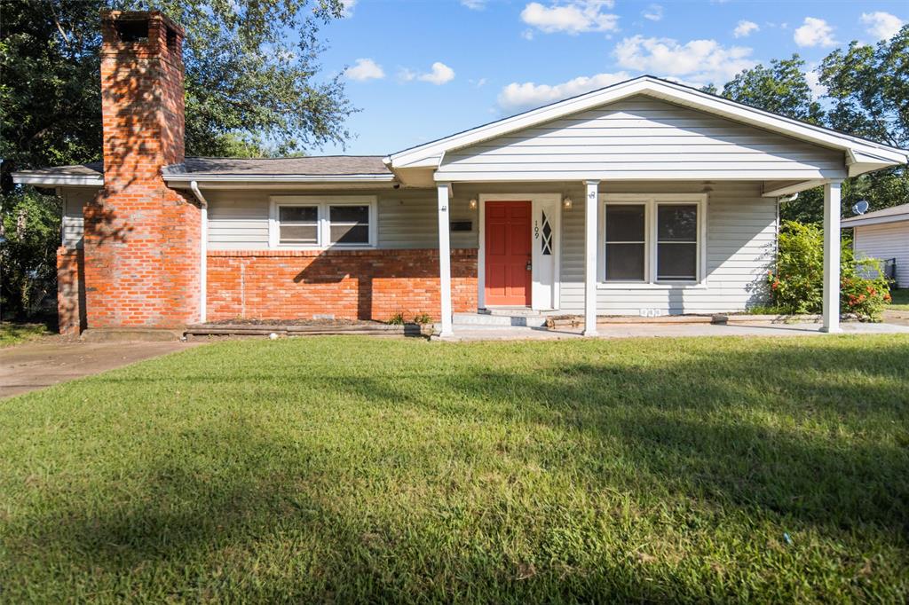 a front view of a house with a yard and garden