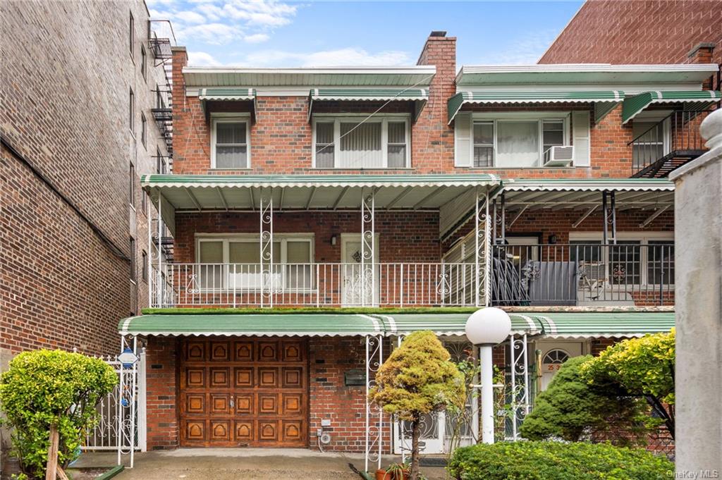 Two family property featuring a balcony and garage