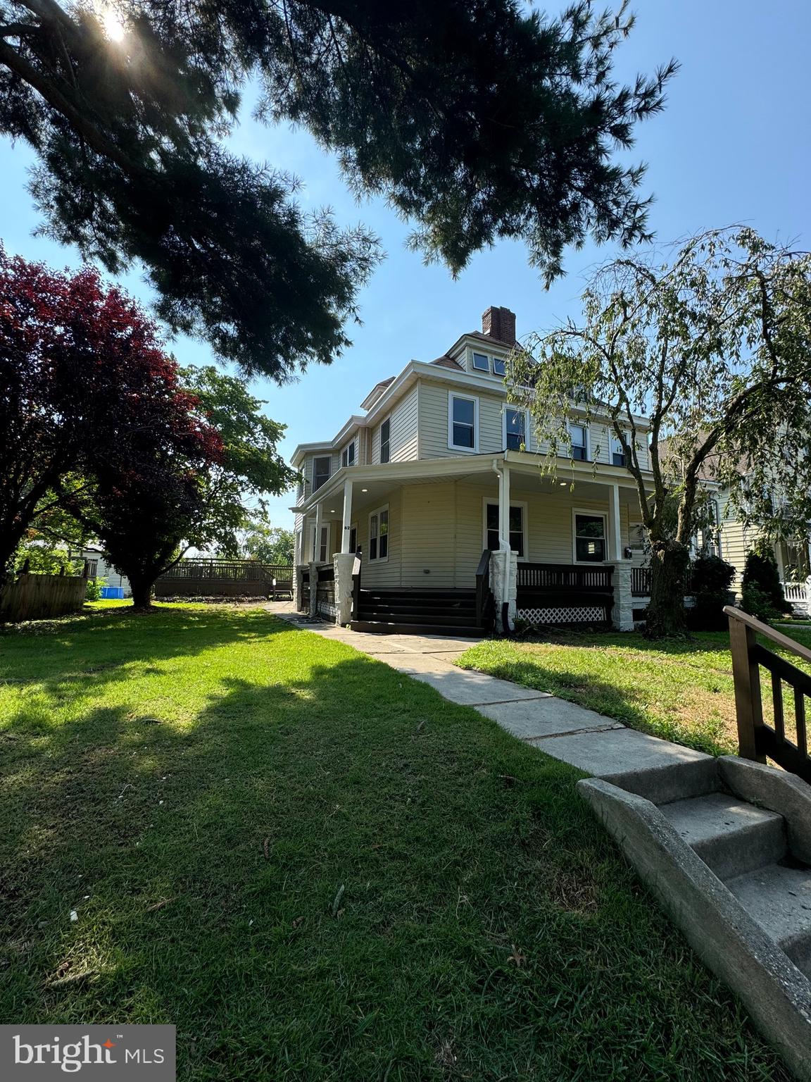 a front view of a house with a garden and yard