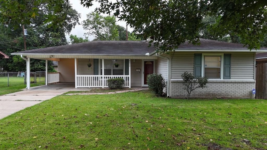 a view of a house with a yard and sitting area