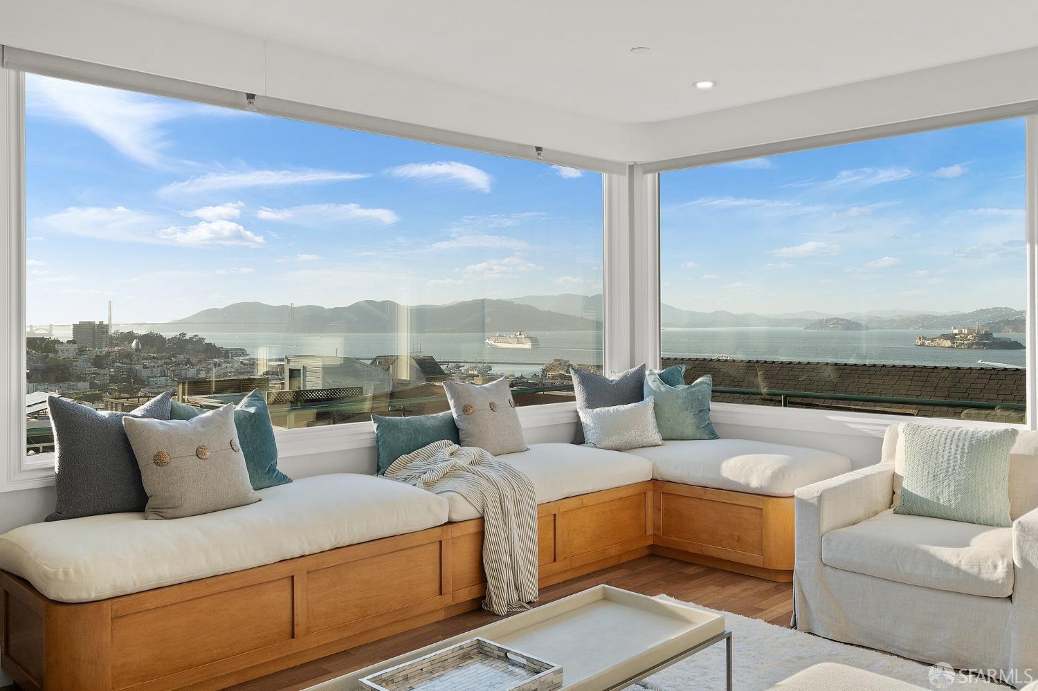 a living room with furniture and a floor to ceiling window