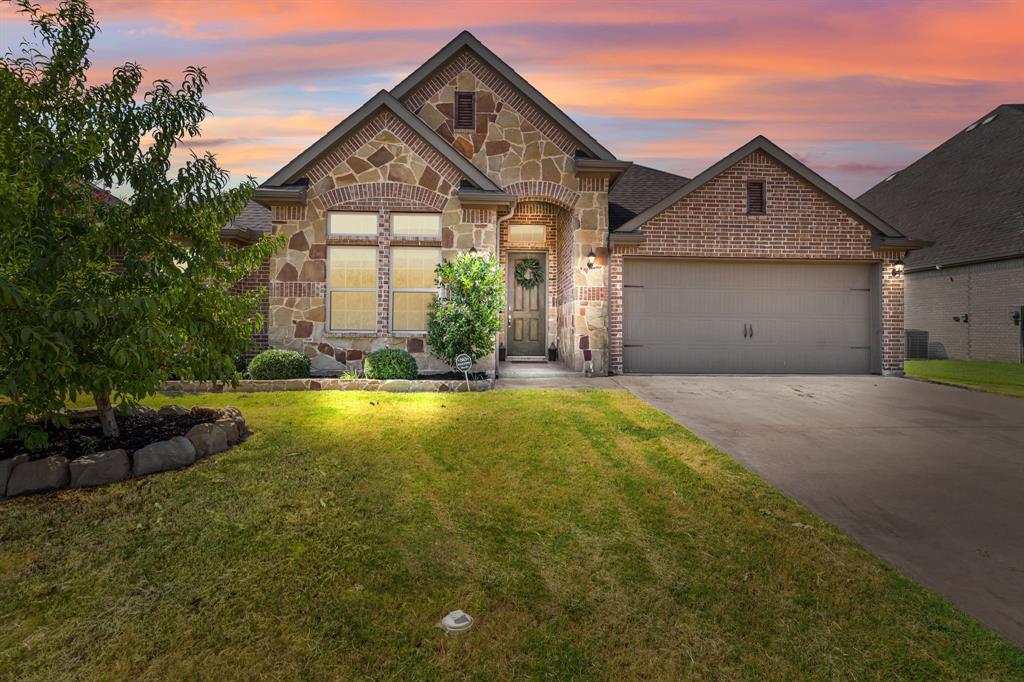 a front view of a house with a yard and garage