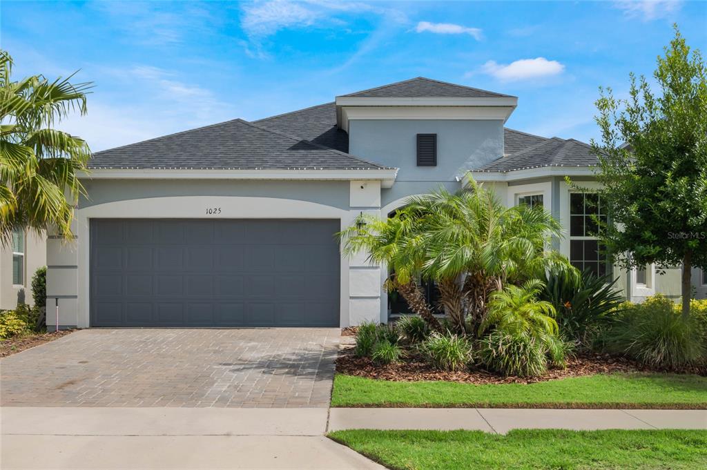 a front view of a house with a yard and garage