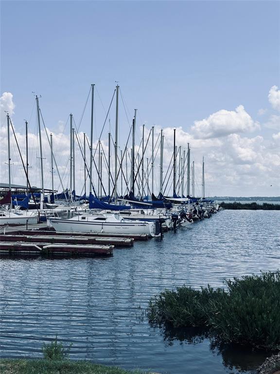 a view of ocean with boats and trees in the background