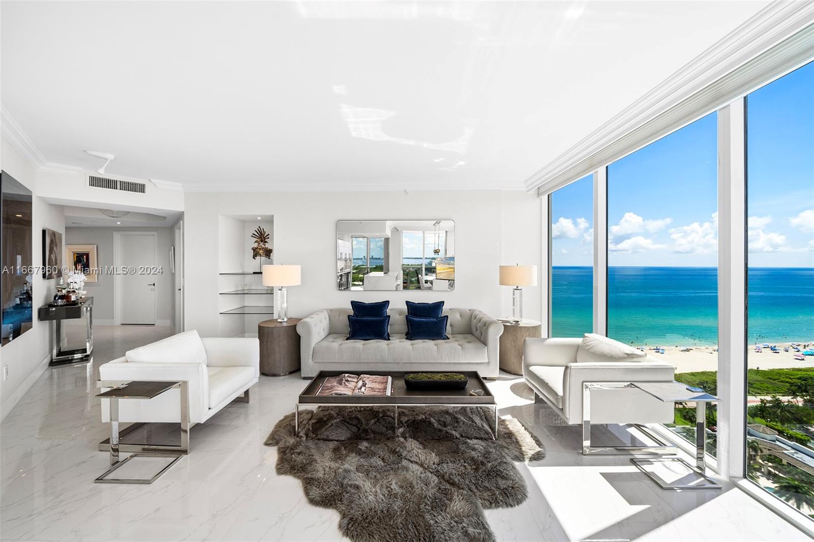 a living room with furniture and a floor to ceiling window