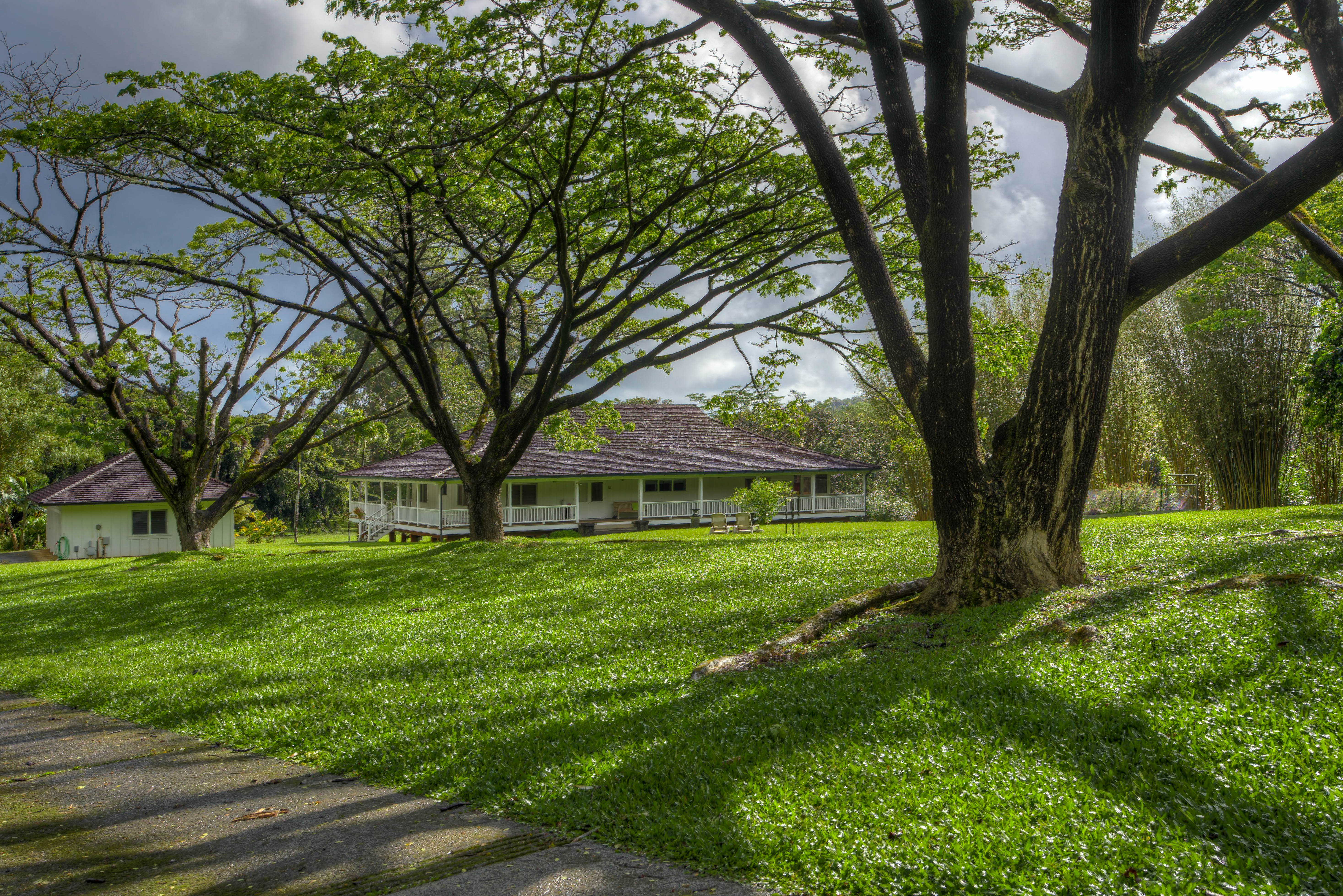 A classical Plantation style home with a separate 4 car garage structure.