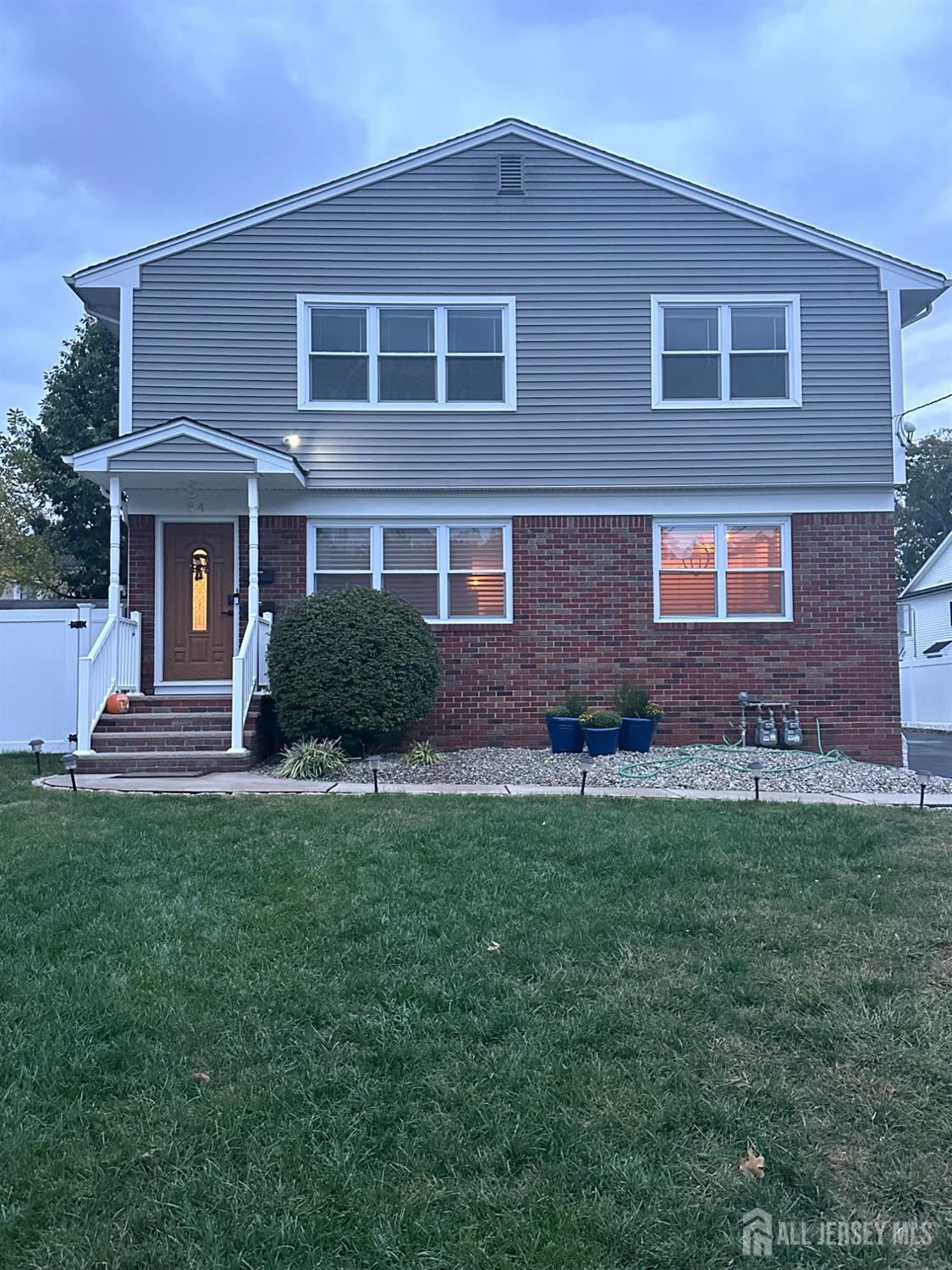 a front view of a house with a garden