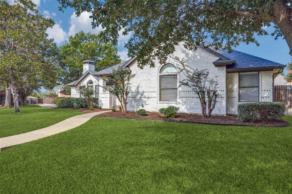 a front view of house with yard and green space