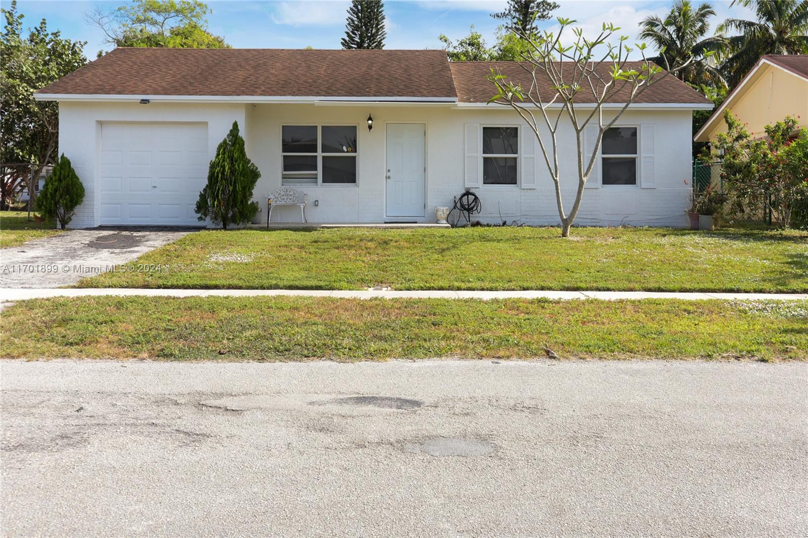 a front view of house with yard and sitting space