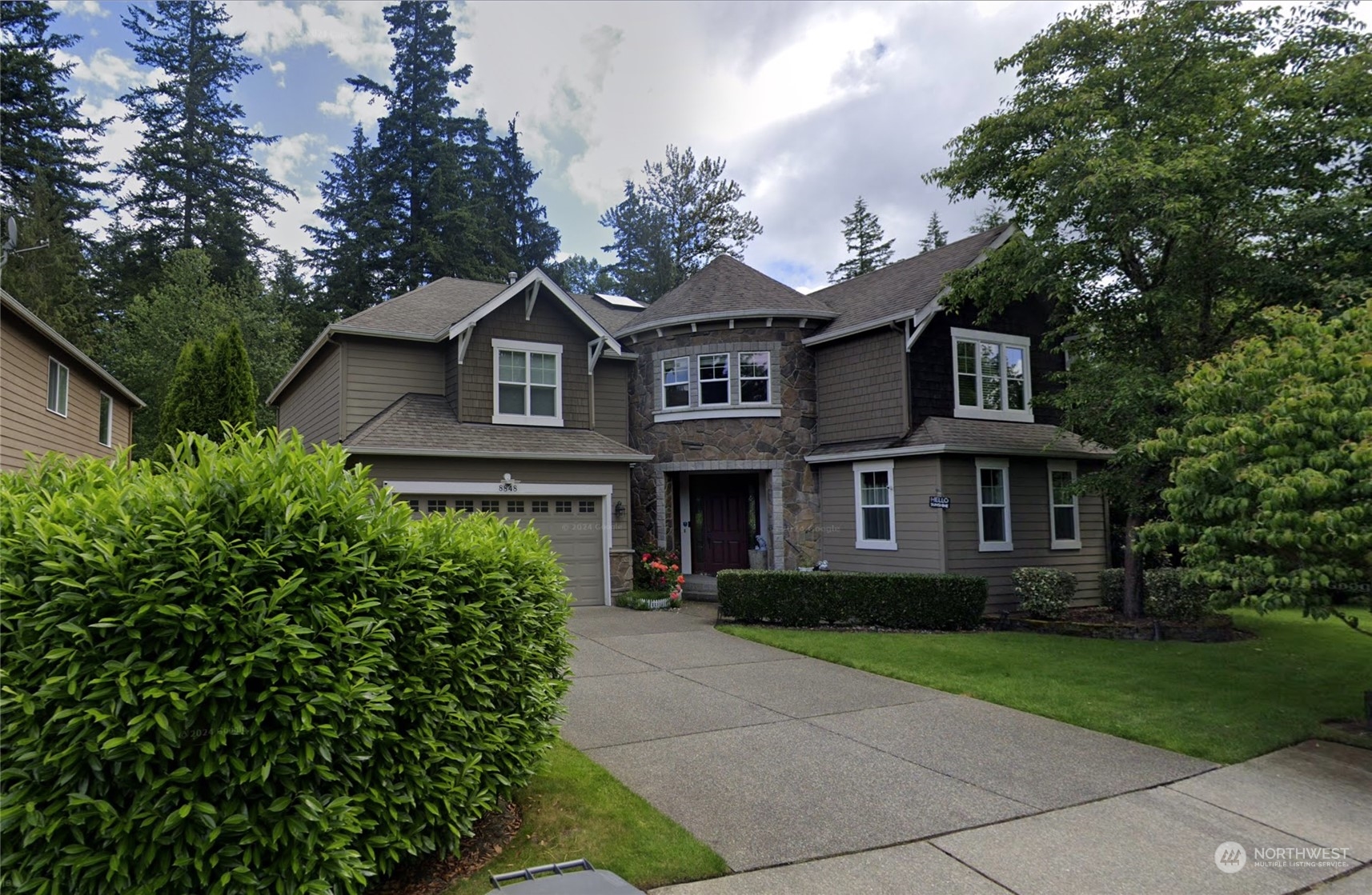 a front view of a house with a garden