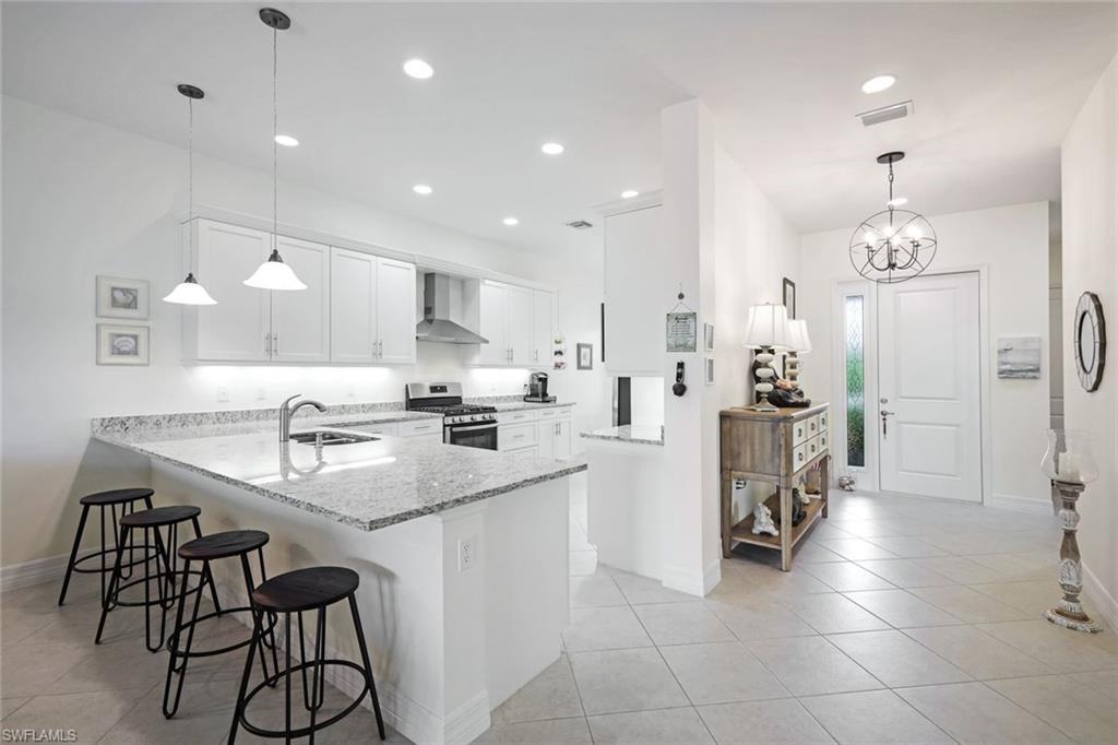 a kitchen with stainless steel appliances kitchen island granite countertop a sink and cabinets