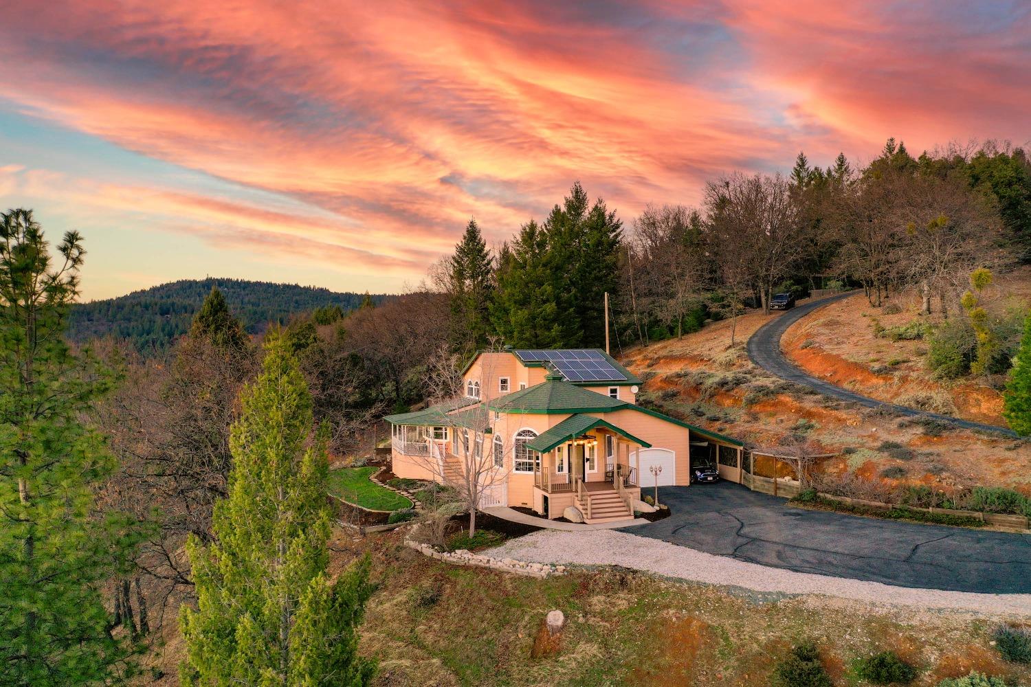 an aerial view of a house with a yard basket ball court and outdoor seating