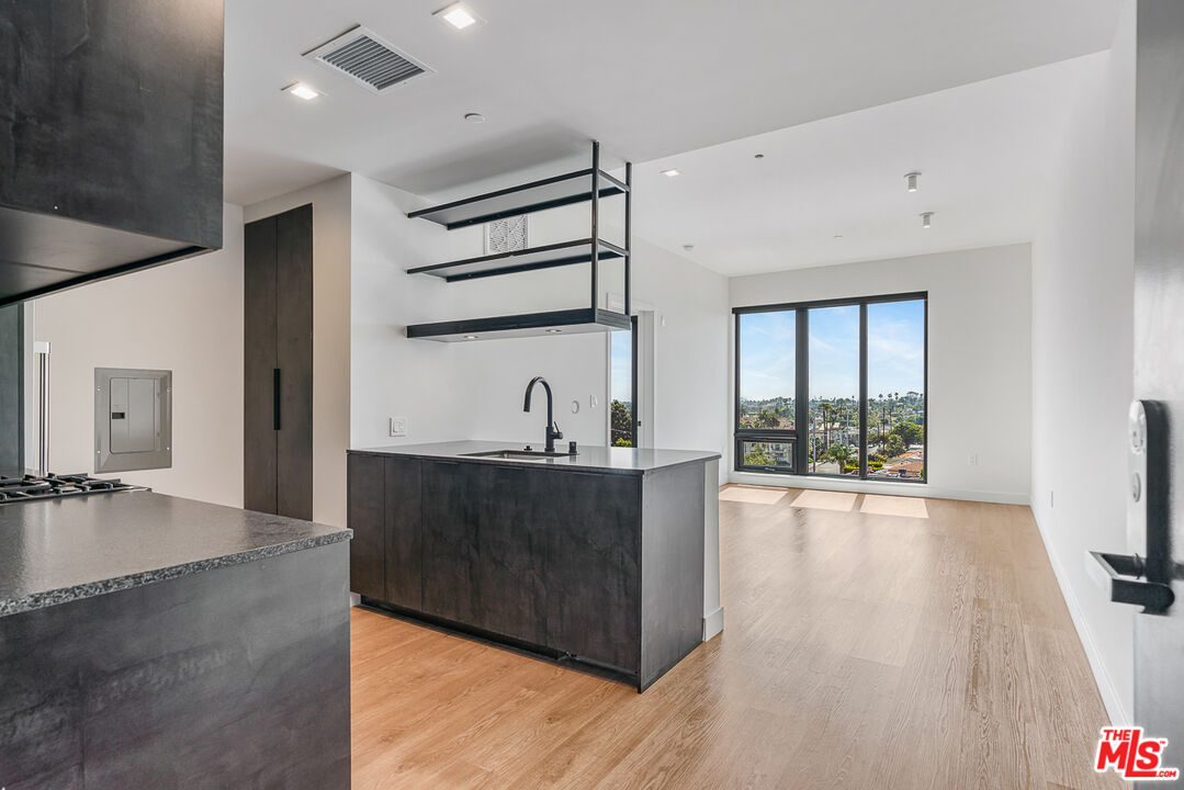 a view of a living room a flat screen tv and floor to ceiling window