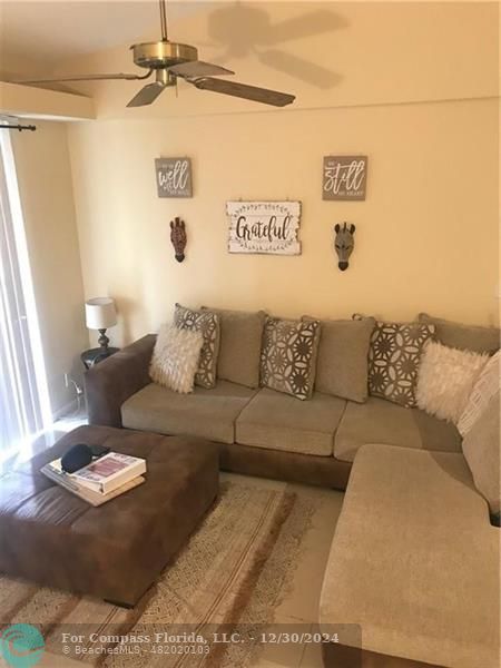 a living room with furniture and a rug