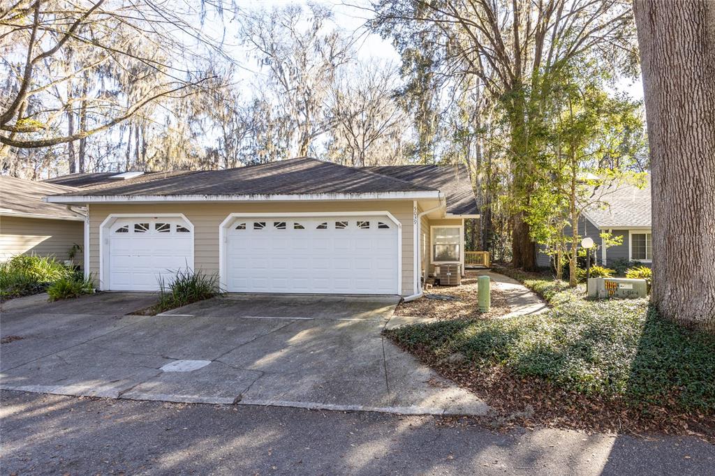 a view of a house with a yard and garage