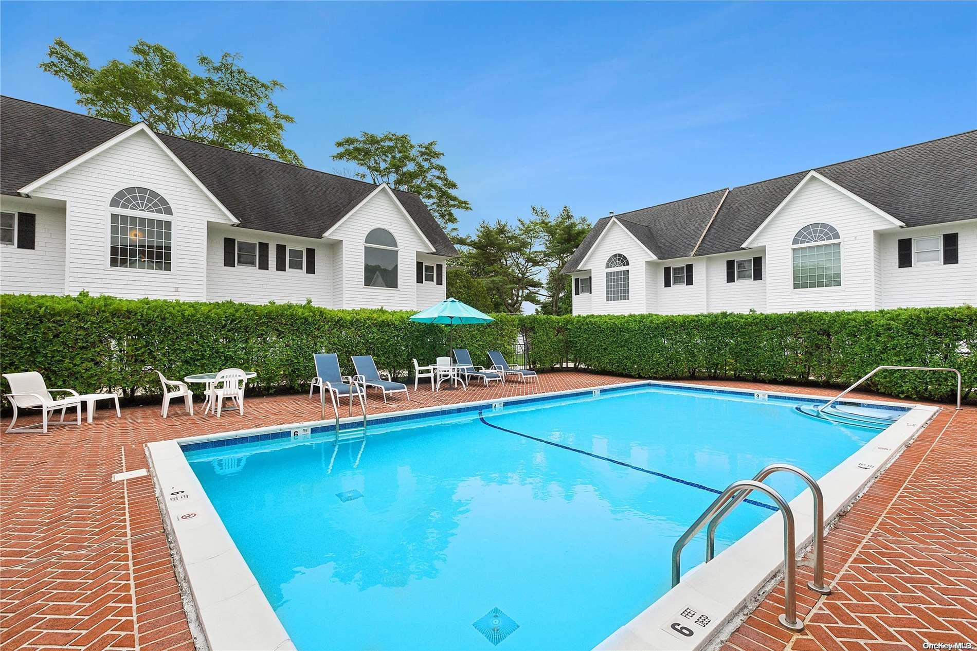 a view of a house with pool and chairs