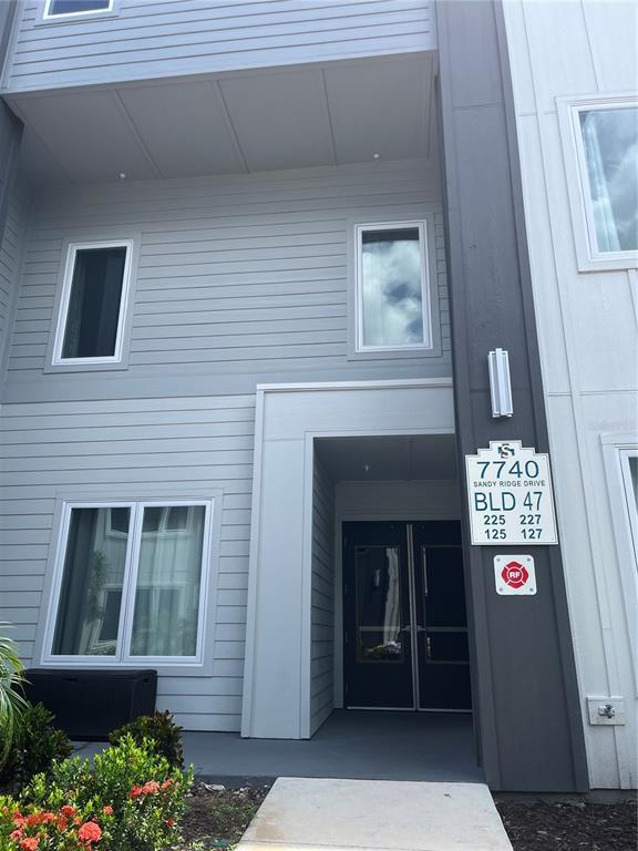 a front view of a house with sign board