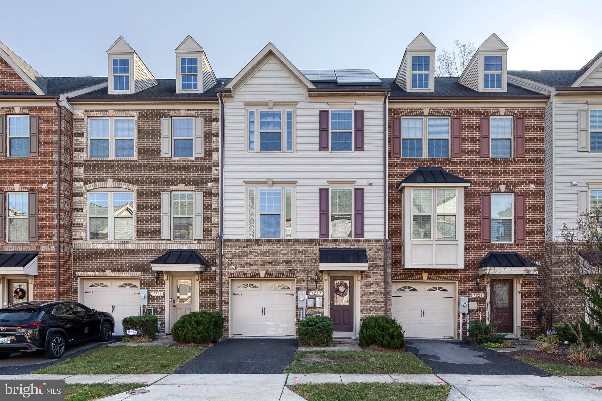 a front view of a residential apartment building with a yard