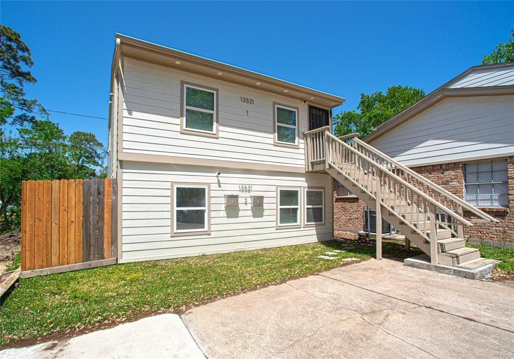 a house with a small yard and wooden fence