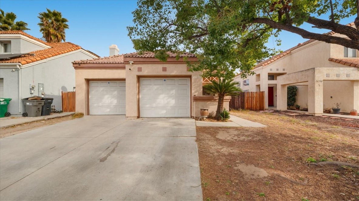 a view of a house with a yard and garage